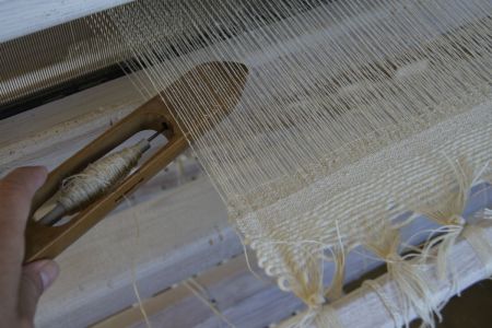 Weaving With Shuttle In Hand